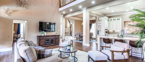 Welcome to Plano! Relax and make memories in this open living room and kitchen.