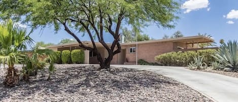 Front entrance with covered parking and as well as the driveway area