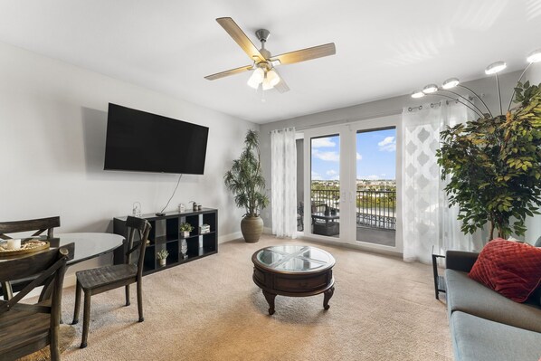 Living Area with Lake/Light Show Views, Flat Screen TV, Sleeper Sofa and Private Balcony Access