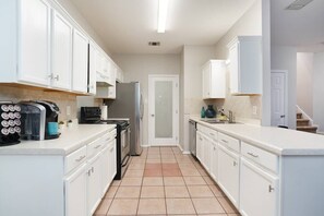 Kitchen with door to laundry room and half bath.