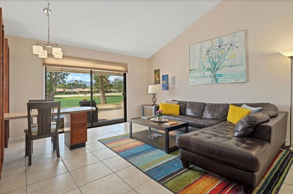 Most comfrotable bright living room with a small dining table of desk