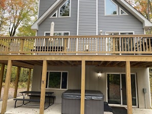 Hot tub and picnic table under deck