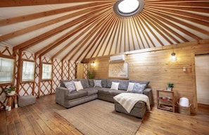 Such a cozy space with beautiful wood and natural light from the Yurt design.
