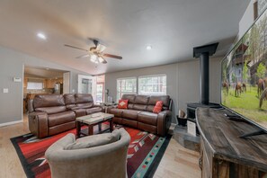 Gather around the wood-burning fireplace & open picture windows for bright, cozy living.