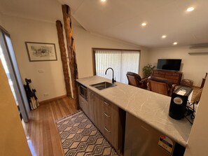 Large modern kitchenette with coffee pod machine and microwave