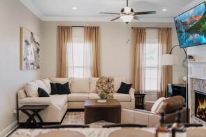 Relax in the cozy and stylish living room, complete with contemporary décor and ample natural light, ideal for unwinding after a long day.