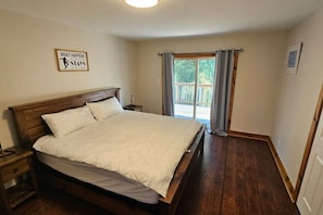 Master bedroom located on the upper level of the property with king bed looking towards W/O balcony