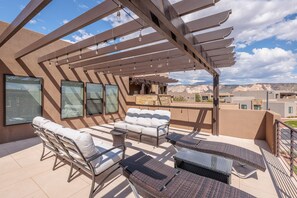 Balcony Patio Side View - Enjoy the weather under the pergola while sitting in our comfortable patio furniture.