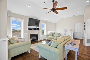 Living room fireplace and media - Nestle up next to the fireplace and LED TV after a day at the beach.
