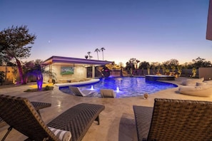 Relax on the poolside lounge chairs with sunset views.