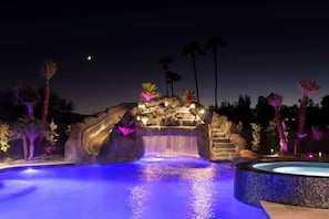 The grotto and water slide add adventure to your backyard retreat.