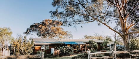 Ilkley House is the largest cottage at Budgee Budgee Farm with five bedrooms, backyard amenities, and Mudgee valley views
