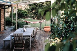 Ilkley House - A spacious verandah is the perfect spot to enjoy the stunning sunset views, complete with a BBQ and outdoor setting. 
