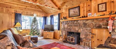 Cozy up by the fireplace in our rustic wood cabin living room.