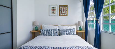 Enjoy this cozy queen bed with lots of natural light and black out curtains!