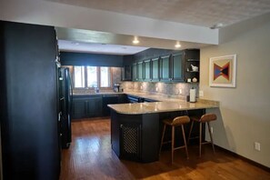 Spacious kitchen with plenty of countertop.
