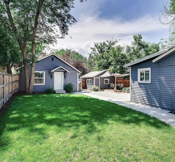 View from the front gate. Carriage house is at the end of the path to the left.