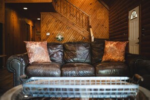 A cozy living room with a fireplace and comfortable seating for everyone