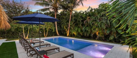 Escape to a private Delray Beach paradise: Featuring an amazing pool, cozy loungers, a sun shelf, and surrounded by palm trees, our secluded retreat is your ideal vacation haven.