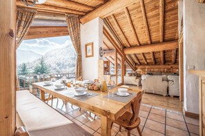 Savour every meal at our dining table, set against the backdrop of stunning alpine views.
