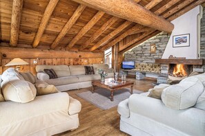 Experience comfort and serenity in our elegantly appointed living room, complete with a wood-burning fireplace.