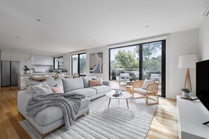 A second living area features a comfortable, grey couch, stylish decor and a flat-screen HDTV
