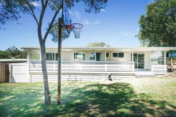 This lovely bungalow is nestled on a grassy backyard with plenty of space for kids to play.