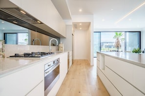 Designed around a central island, the high-end kitchen features a butlers’ pantry and breakfast bar.

