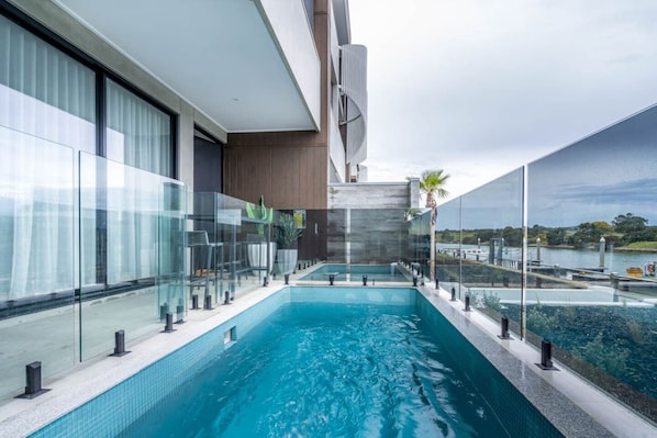 Cool off with a splash in the swimming pool, directly overlooking the water.