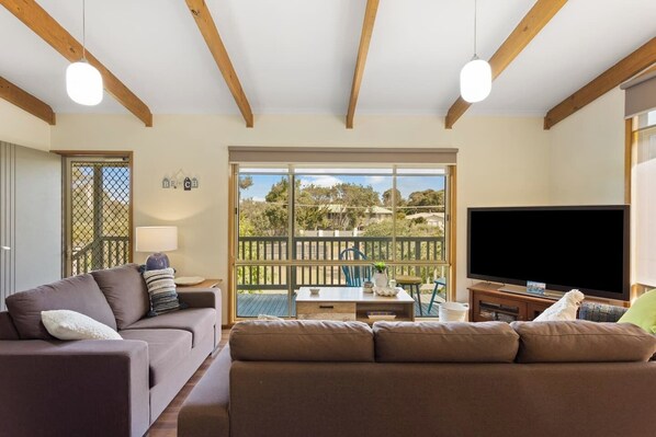  The open plan living room opens straight to the deck creating a lovely transition between the indoors and out.
