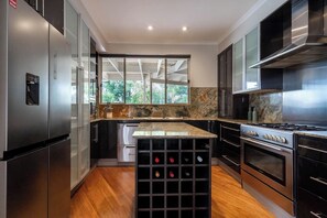 Cook up a feast within the gourmet kitchen, on top-quality appliances and granite benches.