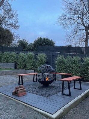 Cosy up around the outdoor fire pit in the cooler months.