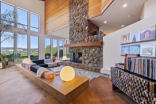 Sunken living room with gas fireplace and large collection of records 