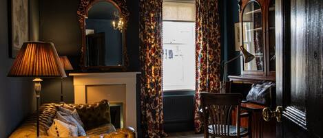 A formal sitting room with a writing desk at The Townhouse Sherborne, Dorset