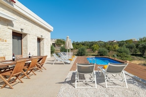The pool area is equipped with modern sunbeds, parasols and an outdoor shower!