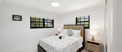 You enter your queen bedroom after a day of adventure or work, and you're greeted by the inviting embrace of a sumptuous queen-size bed. The soft, plush linens and an array of pillows promise a night of deep, rejuvenating sleep. The elegant decor and calming color scheme create a soothing atmosphere that allows you to unwind completely.