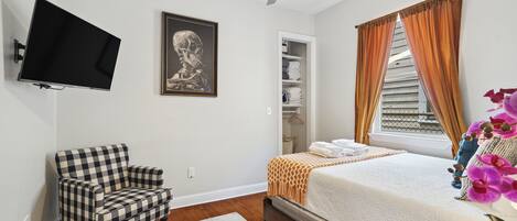 Bedroom 4- smart tv, overhead fan, queen bed, storage space, thoughtfully designed, natural light, hardwood floors