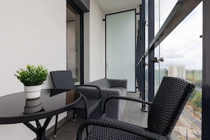 Spacious balcony with outdoor furniture.
