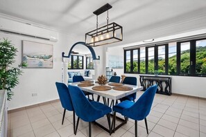 The dining room has a dining table for 6 guests an offers tons of natural light