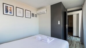 Bedroom with a comfortable double mattress, closet space and an AC unit #bedroom