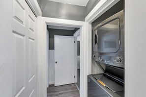 Hallway to bedrooms with laundry