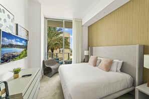 The bedroom with a puffy king-size bed, HD TV and private balcony