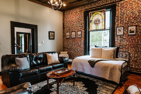 Living room includes 15' ceilings, stained glass window with black out shades