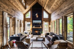 The main living area is surrounded by windows bringing in natural light and highlighting the capitvating views of the Smoky Mountains.