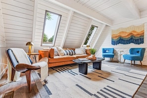 "A-Frame allure, streaming sunlight through skylights, and the luxury of a Poly & Bark leather sofa, all in front of an massive HDTV for your ultimate relaxation."