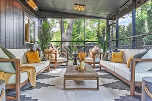 Patio living space adjoining the indoor living room. Screened in, with dual heater to stay warm during those cooler nights.