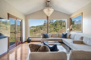 Comfortable couch seating for 12 adults on two large sectionals. 75" 4K TV.