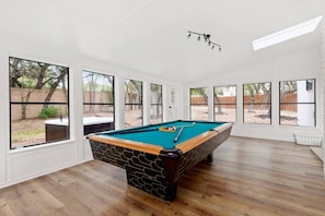 Bask in the radiance of the sunroom, adorned with pristine white walls and an abundance of windows.