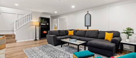 Relax and entertain in style with a spacious, open living room featuring abundant seating options.