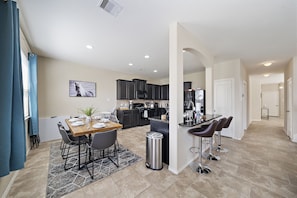Spacious dining table that sits 6 with full tableware and silverware included.